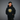 Person wearing a black hoodie with a sun design and 'Rooted' text on a gray background